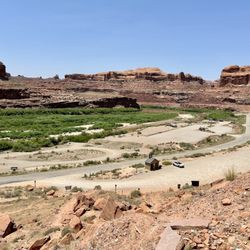 Corona Arch Trail - Starting the 3 mile hike to and from Corona Arch, my car was siting alone in the parking lot below. 109 degrees outside can be a deterrent.