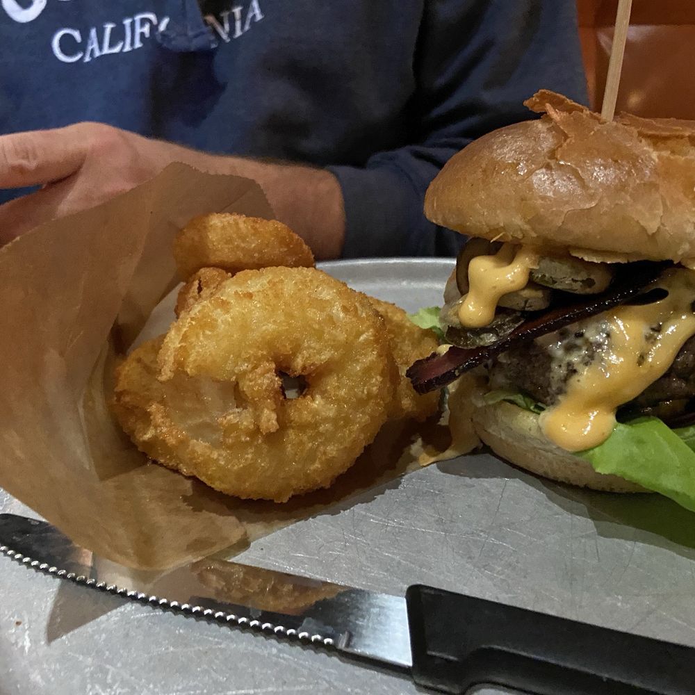 Sriracha Burger with onion rings.