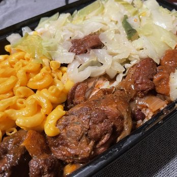 Aunty Joy's Jerk & Pizza - Brown stew chicken with cabbage and mac and cheese - Caribbean Near Me - Chicago, Illinois Aunty Joy's Jerk & Pizza - Brown stew chicken with cabbage and mac and cheese - Caribbean Near Me - Chicago, Illinois