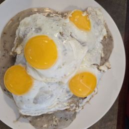 Dad's Breakfast (1 of the plates). Biscuits and gravy with sunny, happy eggs on top. Dad's Breakfast (1 of the plates). Biscuits and gravy with sunny, happy eggs on top.