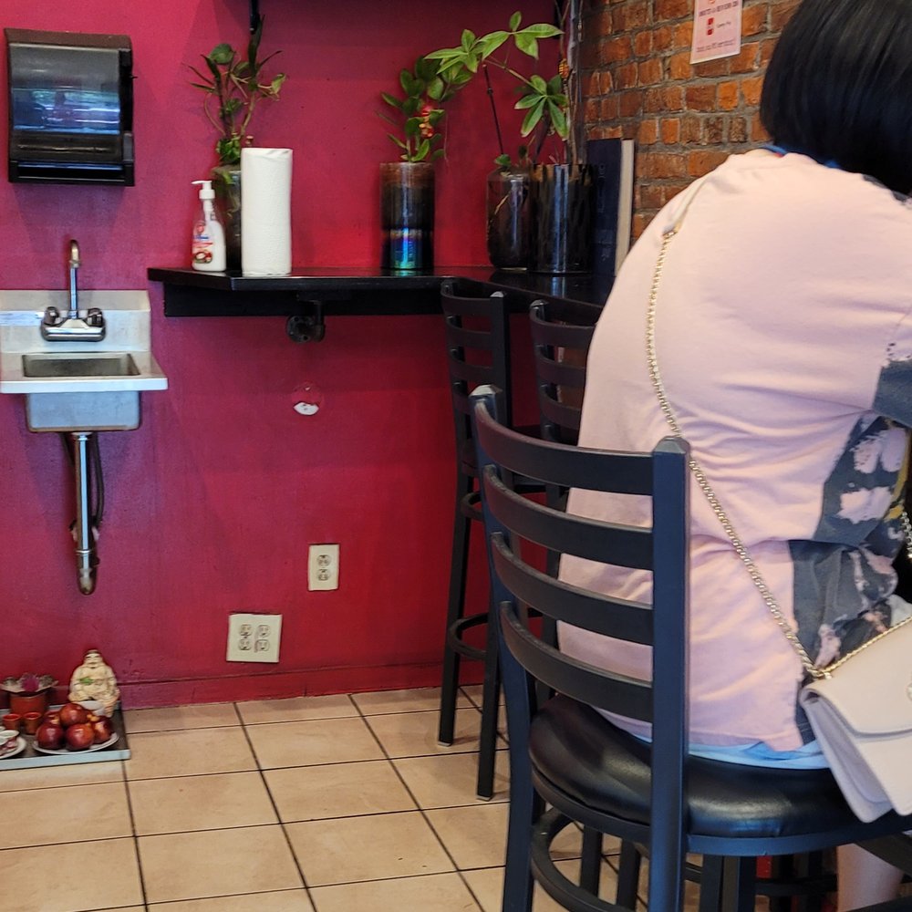 Yummy Pho - a woman sitting at a table in a restaurant - Vietnamese Near Me - Philadelphia, Pennsylvania Yummy Pho - a woman sitting at a table in a restaurant - Vietnamese Near Me - Philadelphia, Pennsylvania