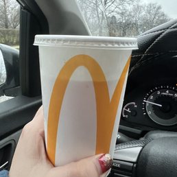 a hand holding a cup of coffee