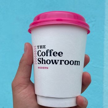 The Coffee Showroom - a hand holding a cup of coffee - Coffee & Tea Near Me - Miami, Florida The Coffee Showroom - a hand holding a cup of coffee - Coffee & Tea Near Me - Miami, Florida