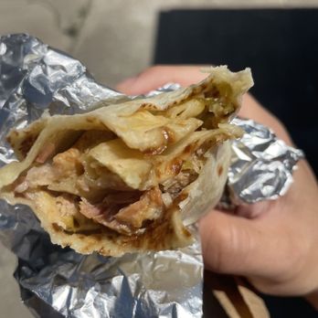 Marie's Mexican Kitchen - a hand holding a burrito - Mexican Near Me - Merced, California