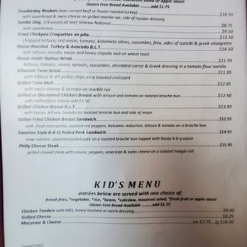 Doubleday Cafe - Menu - The menu from Doubleday Cafe displays a list of sandwiches, including options like doublebred Reuben, jumbo dog, fried chickpea croquettes, and house roasted turkey & avocado B.L.T., with prices ranging from $4.50 to $15.95. It also includes a kid's menu with items such as chicken tenders, grilled cheese, and macaroni & cheese, with prices from $5.95 to $10.50. The menu notes that all sandwiches are served with dill pickle chips and one choice of side, and mentions gluten-free bread options available for an additional $1.75. - American Near Me - Cooperstown, New York