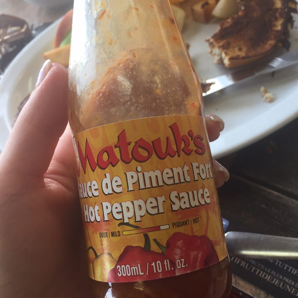 Tutti Frutti - a person holding a bottle of hot pepper sauce - Breakfast & Brunch Near Me - Saint-Hyacinthe, Quebec Tutti Frutti - a person holding a bottle of hot pepper sauce - Breakfast & Brunch Near Me - Saint-Hyacinthe, Quebec