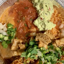 Menudo over a bed of rice with garnishes Menudo over a bed of rice with garnishes