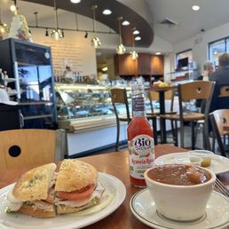 Turkey and tomato sandwich on focaccia bread, with a cup of the goulash soup.