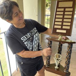 Clock & Trophy Shop - Teacher liking her new trophy.