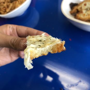 The Pasta Place - a hand holding a piece of bread - Pasta Shops Near Me - Lincoln, Nebraska