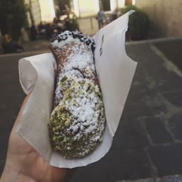 Cannolo dipped in chocolate chips and pistachios Cannolo dipped in chocolate chips and pistachios