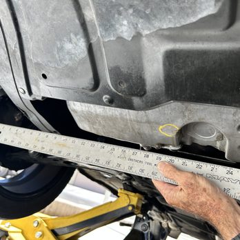 AAA - Showing how the "Stinger" bar hit and bent the frame and showing crack of oil pan after being dropped on "Stinger" by AAA Driver - Auto Repair Near Me - Henderson, Nevada