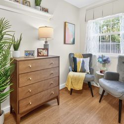 Artis Senior Living of Potomac - Natural light-filled memory care suite with private bath and space for comfortable seating, dresser, and personal touches.