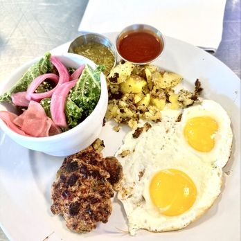 Smothered - 2 egg breakfast with turkey sausage, kale salad, smashed potatoes and sides of red and green chile. - Breakfast & Brunch Near Me - Albuquerque, New Mexico