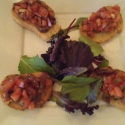 Zahir's Bistro - Bruschetta - Italian crostini, organic Roma tomatoes, fresh basil, pine nuts, Kalamata olives, and aged balsamic vinegar