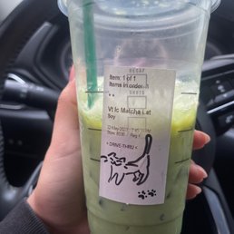 a hand holding a cup of matcha tea a hand holding a cup of matcha tea