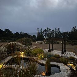 Seafoam Lodge - Fountain and pond in front of a seated area that would be perfect for intimate weddings and services