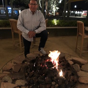 Gulfstream - Fire pit and outdoor setting.. Cousin Mick was happy to be here in California. - New American Near Me - Newport Beach, California Gulfstream - Fire pit and outdoor setting.. Cousin Mick was happy to be here in California. - New American Near Me - Newport Beach, California