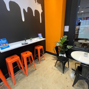 Rush Bowls - a table with four orange stools - Juice Bars & Smoothies Near Me - Denver, Colorado