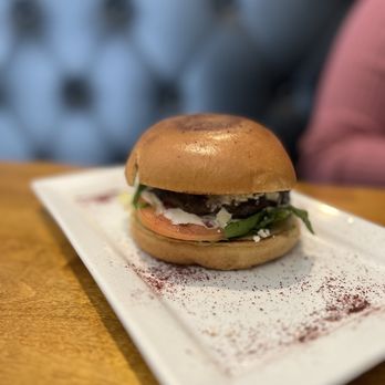 Olive - a burger on a plate on a table - Lebanese Near Me - New Orleans, Louisiana Olive - a burger on a plate on a table - Lebanese Near Me - New Orleans, Louisiana