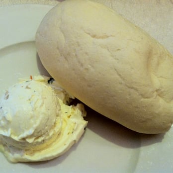 French Quarter Grille - Warm soft rolls with roasted garlic and herb butter - American Near Me - Austin, Texas