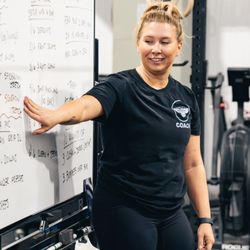 Coach Colette goes over the days workout with the 5AM class.