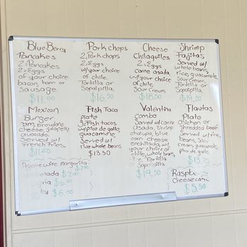 El Comal - Whiteboard menu at El Comal in Santa Fe, NM, featuring Mexican dishes like tacos, enchiladas, and sopapillas with prices. - Mexican Near Me - Santa Fe, New Mexico