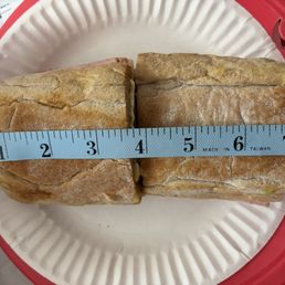 The smallest of the 2 and the ruler is lined up with the edge.
