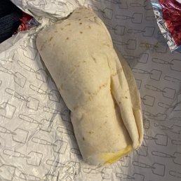 Breakfast burrito, bursting from each end Breakfast burrito, bursting from each end