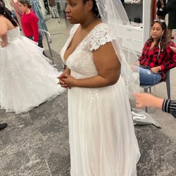 David's Bridal - Sad bride in wedding dress with completed application of appliqués on the sleeves wondering why she gets treated differently than others