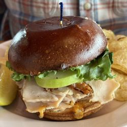 Portland Pie Co. - Acadia turkey apple. Sliced turkey with fresh greens and sliced green apples in brioche roll