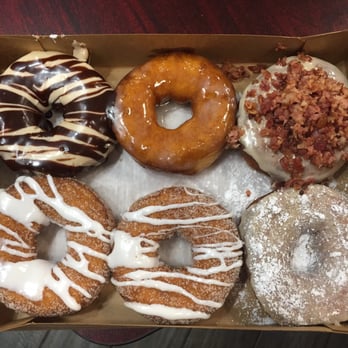 Duck Donuts - Clockwise from top left: Reese's, glazed, maple bacon, French toast and the last 2 are cinnamon bun - Donuts Near Me - Charlottesville, Virginia Duck Donuts - Clockwise from top left: Reese's, glazed, maple bacon, French toast and the last 2 are cinnamon bun - Donuts Near Me - Charlottesville, Virginia