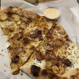 Potato bacon pizza with chipotle sauce on the side Potato bacon pizza with chipotle sauce on the side