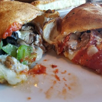 Big Bill's NY Pizza - Combo calzone - meat to the right, vegi to the left.  He will never learn to balance - Pizza Near Me - Centennial, Colorado