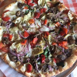 Veggie pizza with mushrooms artichokes red onions and tomato