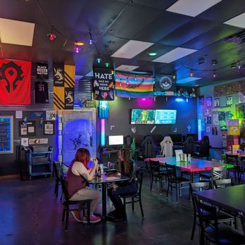 Vault 31 Bar - people sitting at tables with neon lights - Pizza Near Me - Vancouver, Washington