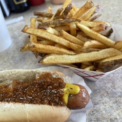 Famous Uncle Al's - Delicious Boars Head Hotdog with chili and onions and fresh cut fries.