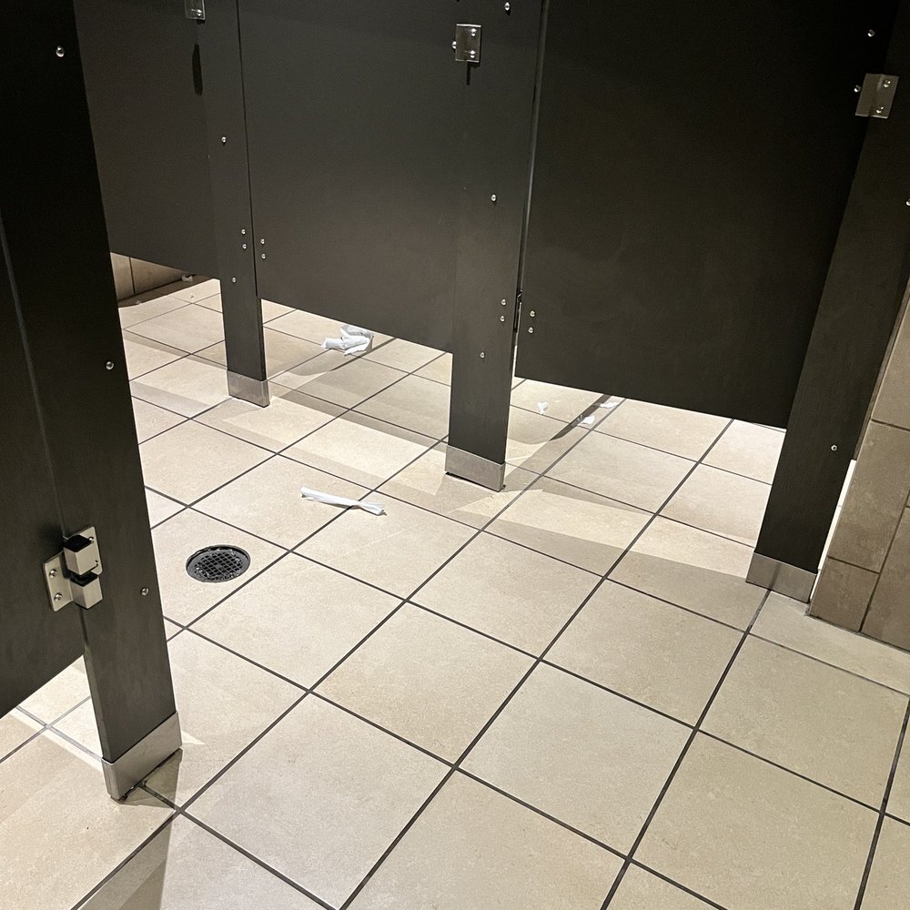 Womens bathroom... tp all over the floors, garbage was over flowing. Lucky there was even tp in the stalls.