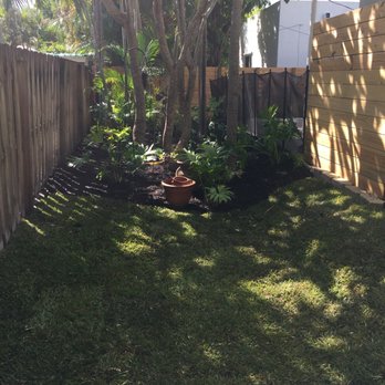 Garmizos - a backyard with a fence and potted plants - Landscaping Near Me - Davie, Florida