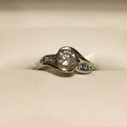 Custom designed .70ct diamond channel set with aquamarine and blue zircon accents in 14K white gold. Absolutely perfect for us!