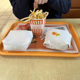 a woman eating a meal at a fast food restaurant