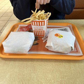 Whataburger - a woman eating a meal at a fast food restaurant - Burgers Near Me - Baytown, Texas