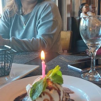 Mankas Grill - Flourless chocolate cake with Ice cream for the birthday girl taking the picture and yours truly in the background - American Near Me - Fairfield, California