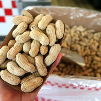 Five Guys - a person holding a bag of peanuts - Burgers Near Me - Edmonton, Alberta