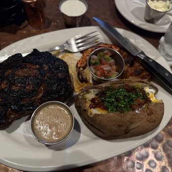 Outwest - Texas spiced Ribeye - 14oz. Blackened shrimp  Loaded potato - Steakhouses Near Me - Kernersville, North Carolina