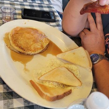 Burnt Biscuit - a person sitting at a table with a plate of food - American Near Me - Brazoria, Texas