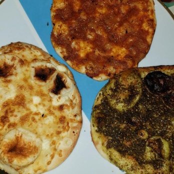 Alida's Bakery - Seasoned naan bread left is feta top is caramelized onion and tomato right is zaatar - Bakeries Near Me - Everett, Washington Alida's Bakery - Seasoned naan bread left is feta top is caramelized onion and tomato right is zaatar - Bakeries Near Me - Everett, Washington