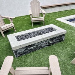 Sierra Pool Co. - Gas fire pit build with a natural stacked stone face. This build also included premium artificial turf and a stucco'd block wall.