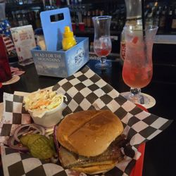 Brisket sandwich with coleslaw and a cold drink