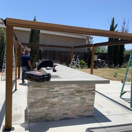 Assembling large gazebo over outdoor bbq island Assembling large gazebo over outdoor bbq island